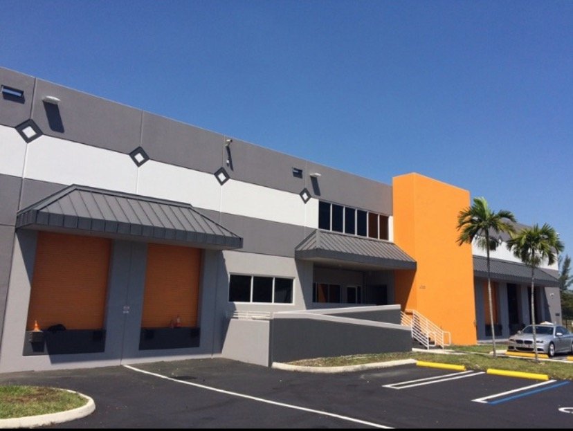 Doral building exterior with gray and white walls and an orange entrance
